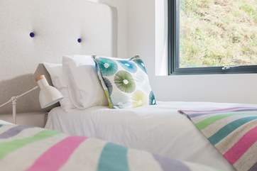 Crisp white linens on quality mattresses with just the right amount of colour.