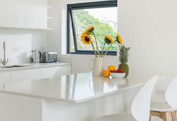 The sleek white marble topped kitchen units are not only practical but rather gorgeous too.