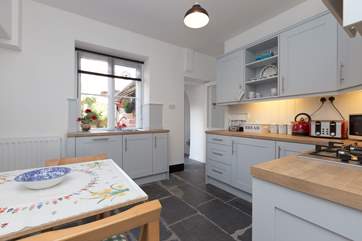 There is a contemporary kitchen and beyond it the back door to the courtyard and a separate WC.