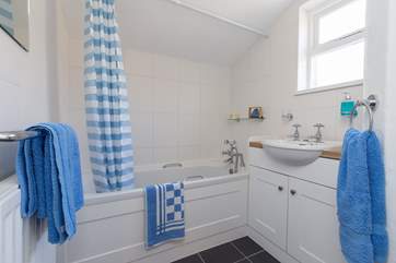 The bathroom is downstairs, off the kitchen. The bath is 3/4 size and there is a wall fitting for the shower.