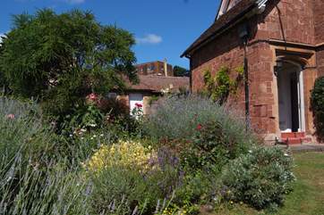 The gardens are not formally enclosed but you have the whole of the side garden as your dedicated outside space. This photo shows your front door.