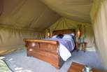 The safari tent bedroom is super romantic! It has a big comfy bed and can offer two feather and down duvets to make it nice and cosy.