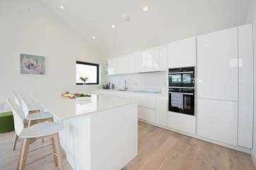 The sleek kitchen is not only great looking but very well-equipped.