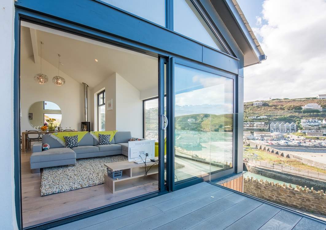 Floor to ceiling glass doors open up to bring the outside in.