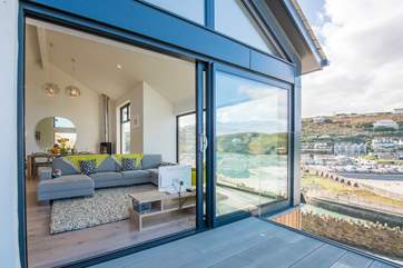 Floor to ceiling glass doors open up to bring the outside in.