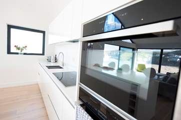 The sleek and well equipped kitchen.