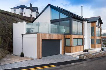 Rock is a super detached house on Lighthouse Hill with a fabulous outside deck, there is parking in front and to the side of the garage.