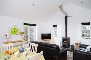Windows on three sides of the living-room allow the light to flood in.