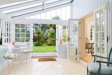The conservatory leads out to the garden and hot tub.