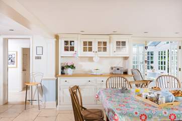 A dresser beside the dining-table houses all the crockery and cutlery.