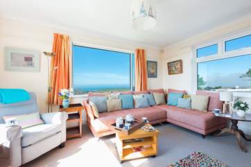 The sitting room with its gorgeous views across open countryside to the sea.