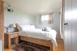Situated at one side of the hut, pretty bedroom one has a double bed.