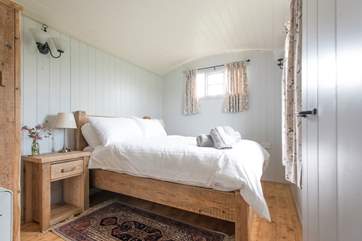 Situated at one side of the hut, pretty bedroom one has a double bed.