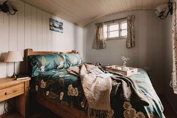 Warm and welcoming, the beautifully furnished main bedroom hosts a sumptuous double bed.