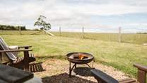 As the evening sun drops, get cosy around the fire-pit.