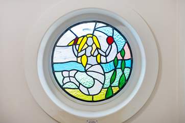 The pretty stained glass window that gives the cottage its name.