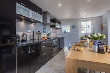 Serving up meals will be a doddle with the dining-table so easily accessible from the kitchen-area.