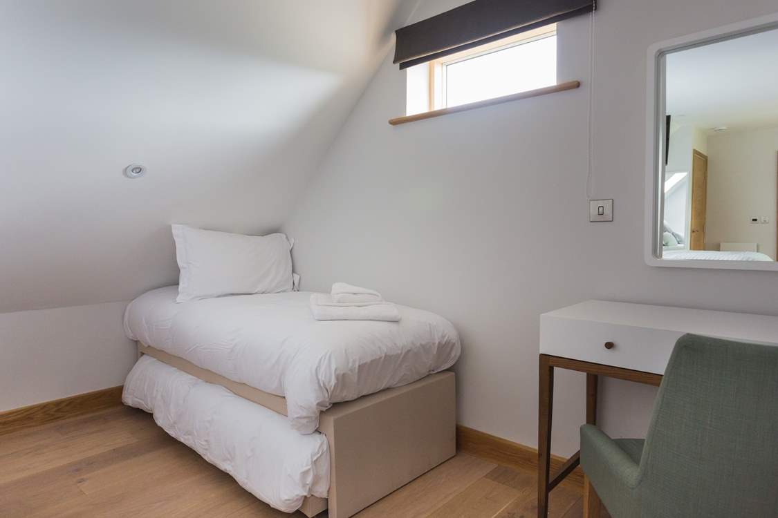 The room adjacent to the master bedroom is where you will find additional sleeping space - a single with a trundle bed underneath, room for two little ones.