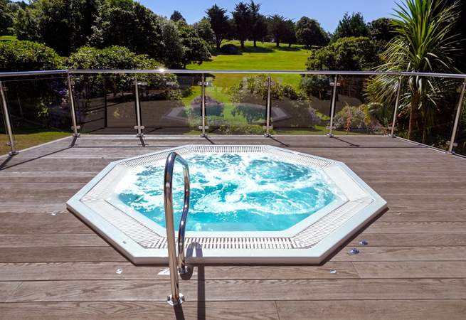 Enjoy a glass of champagne in the outside hot tub at the spa