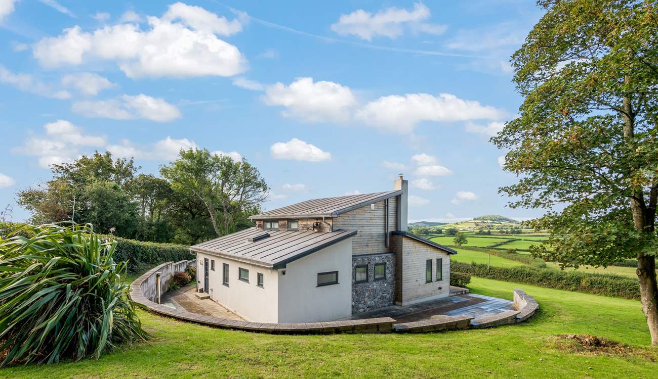 The patio stretches around the whole house.