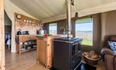 The kitchen-area is fully equipped and includes a  four ring hob, fridge/freezer, microwave, toaster and kettle! There is also the log-fired range to cook on. - Thumbnail Image