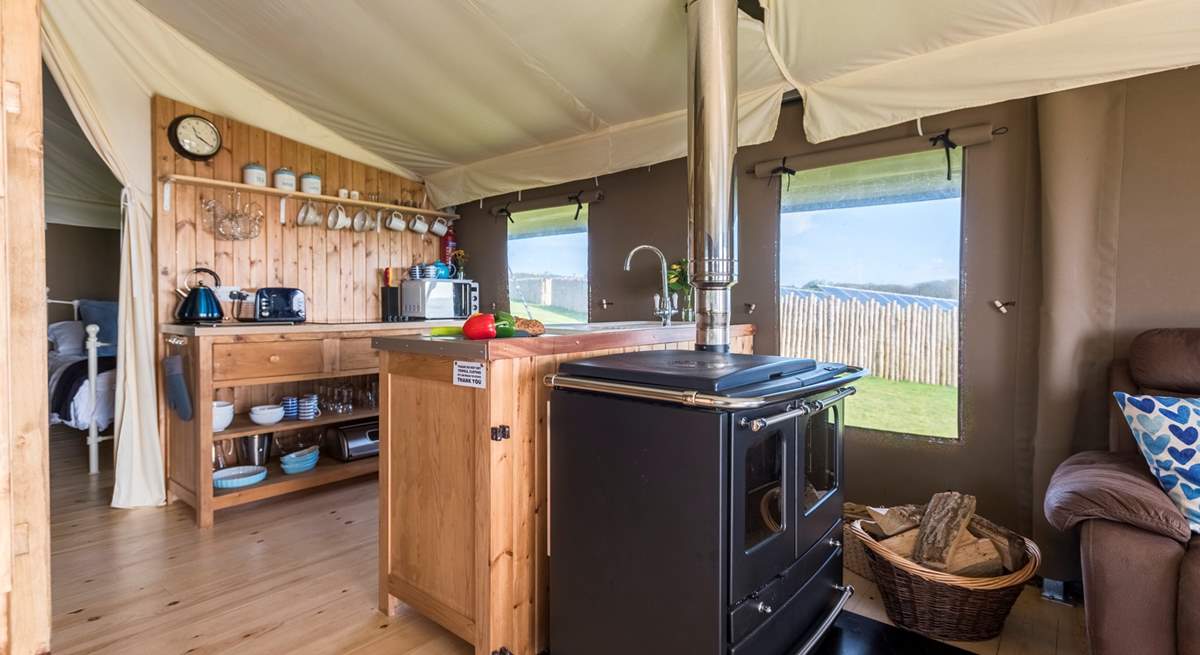 The kitchen-area is fully equipped and includes a  four ring hob, fridge/freezer, microwave, toaster and kettle! There is also the log-fired range to cook on.