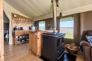 The kitchen-area is fully equipped and includes a four ring hob, fridge/freezer, microwave, toaster and kettle! There is also the log-fired range to cook on.