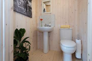 At the back of the tent is your en suite cloakroom with proper flushing toilet and wash-basin.