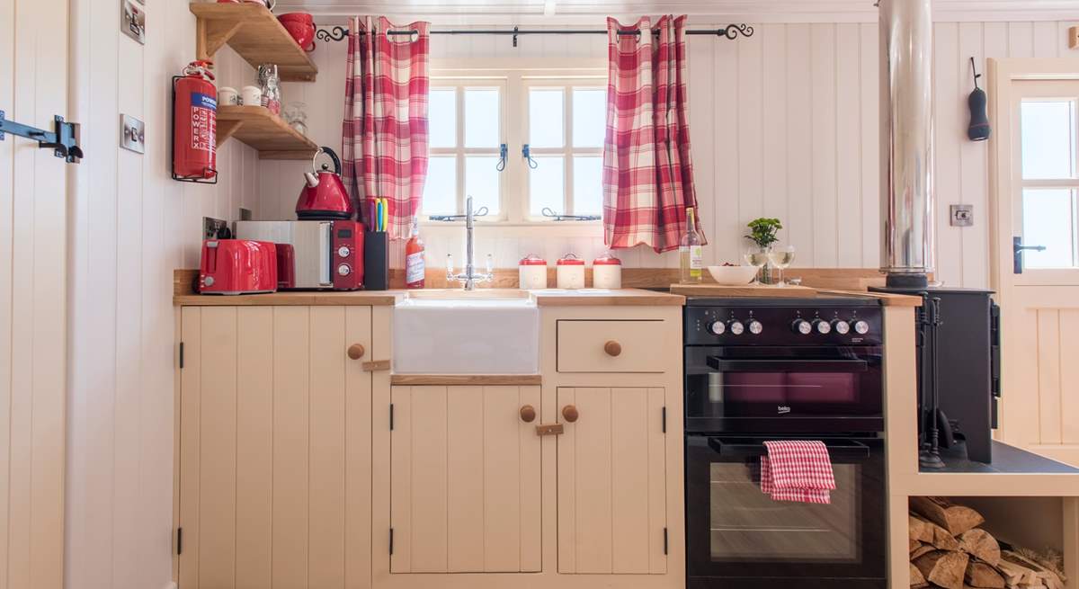 The fully-fitted kitchen has a full-size oven and fridge.