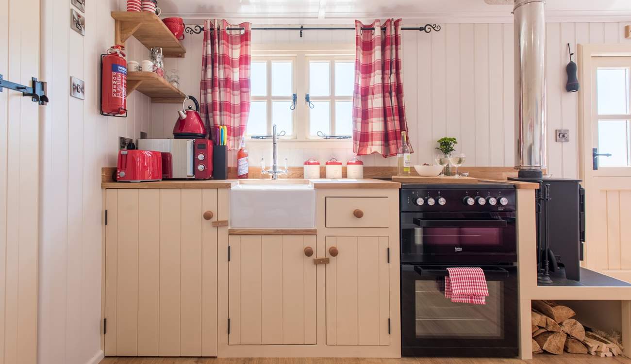 The fully-fitted kitchen has a full-size oven and fridge.