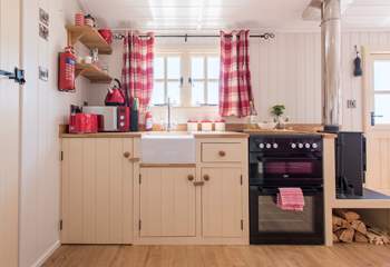 The fully-fitted kitchen has a full-size oven and fridge.