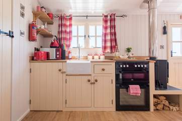 The fully-fitted kitchen has a full-size oven and fridge.