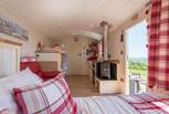 There's a king-size double bed, bunk-beds, kitchen area and en suite shower-room too, perfect for families! 