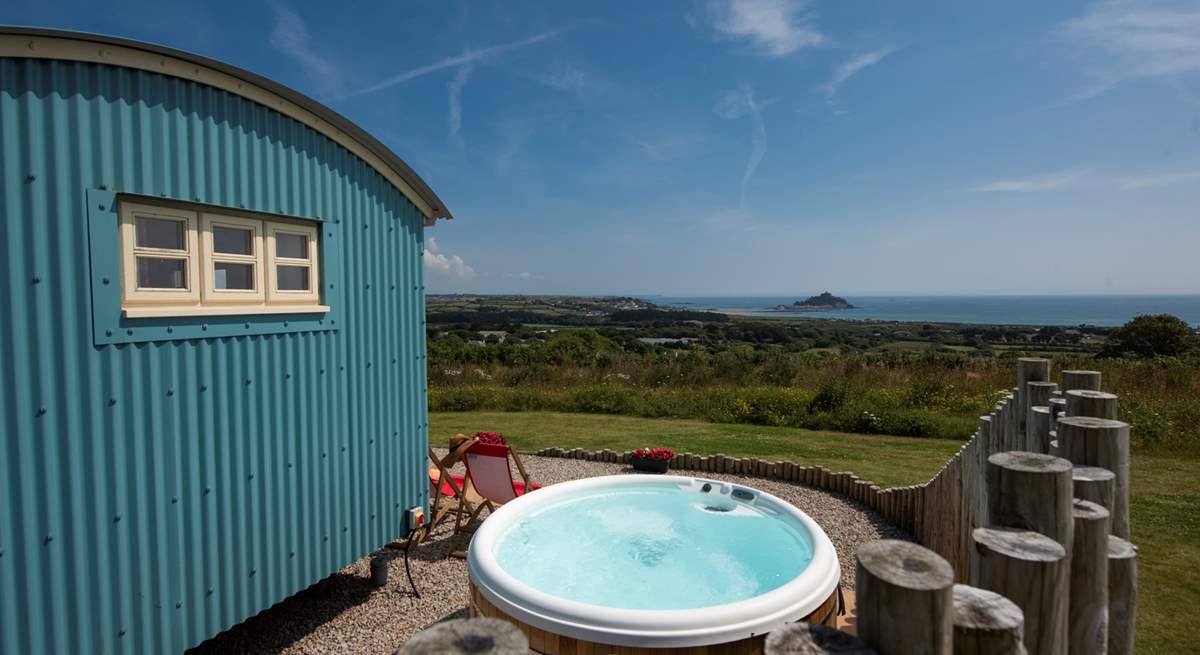 The hot tub sits behind the fence for privacy and shelter and, just like the hut, looks straight out to sea.