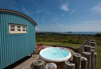The hot tub sits behind the fence for privacy and shelter and, just like the hut, looks straight out to sea.