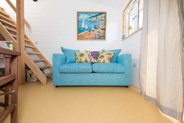 The comfy sofa can pull out to become a bed if required.