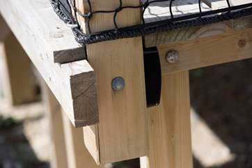 The key safe, as viewed from the side, beneath the veranda, on the left side of the chalet as you stand facing the sea.
