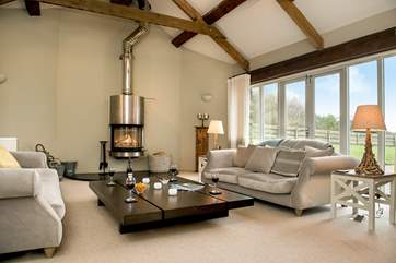 The sitting-room has a wonderful sense of space, with a high vaulted ceiling and large picture windows.