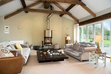 The large sitting-room has plenty of space for everyone to relax, and the wood-burner takes centre stage.