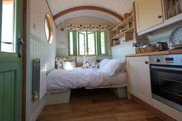 The dining table cleverly converts into a second double bed, if required.