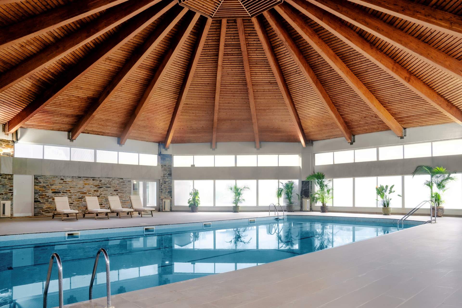 The heated pool is a lovely space with doors out to the hot tub. 