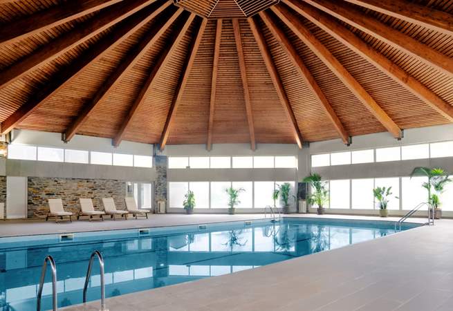 The heated pool is a lovely space with doors out to the hot tub. 