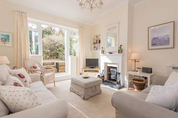 A set of patio doors from the light and cosy living-room lead out to the garden-area.