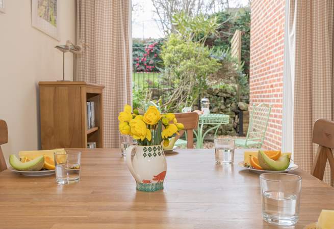 The dining-room has a second set of patio doors that lead out to the very pretty patio and raised garden.