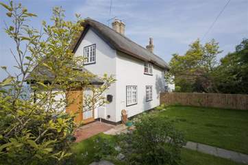 The garden and welcoming entrance to 1 Thatched Cottage.