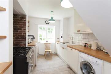 The kitchen has views out to the front garden and a range cooker.