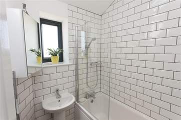 The modern, tiled bathroom on the ground floor.