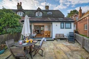 The rear view of this pretty cottage is so inviting.