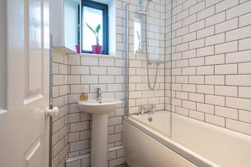 The modern, tiled bathroom on the ground floor.