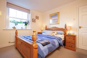 The spacious master bedroom is comfortable and inviting.